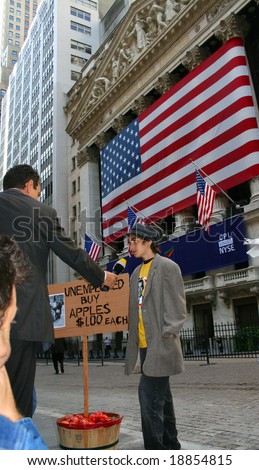 NEW YORK, NY -- SEPTEMBER 30, 2008: A News Reporter Interviews a boy selling apples outside the New York Stock Exchange, September 30, 2008, the day after the record-breaking 777-point drop in the Dow