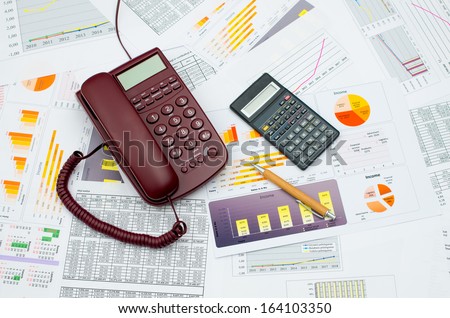 Wired telephone and scientific calculator on table