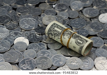 Roll of One Dollar Bills on coins background