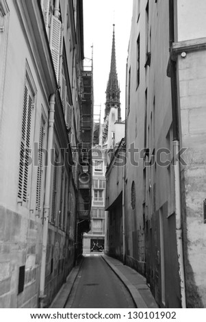 Very narrow street on Ile de la CitÃ?Â?Ã?Â© in Paris, France. Black and white.