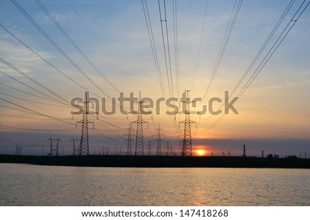 Sunset on the lake and transmission power line. Little noise