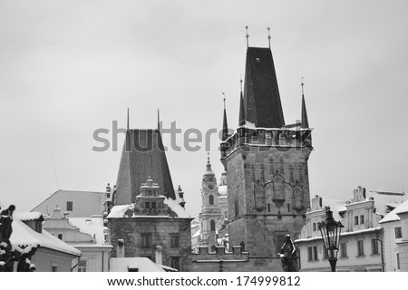 Tower of ancient Charles Bridge in the center of Prague, Czech Republic. Black and white.