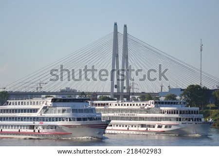 ST.PETERSBURG, RUSSIA - JULY 19, 2014: River cruise ships sailing on the river Neva, outskirts of St. Petersburg.