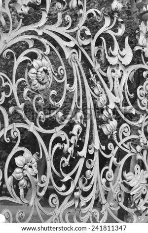 Decorative cast-iron fence of Mikhailovsky Garden in St Petersburg, Russia. Black and white.