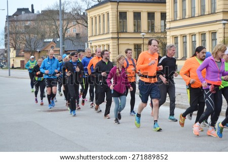 STOCKHOLM, SWEDEN - APRIL 19, 2015: Big group of runners on street in Stockholm.