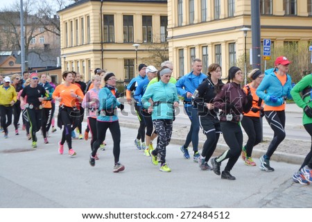 STOCKHOLM, SWEDEN - APRIL 19, 2015: Big group of runners on street in Stockholm.