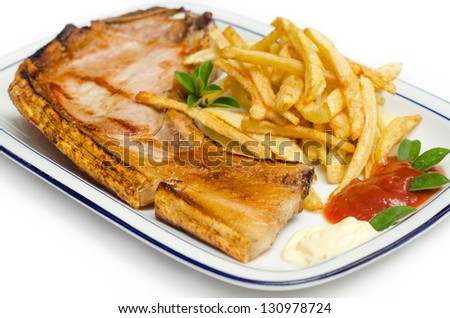 Tray of roasted pork steak with fried chips and condiments
