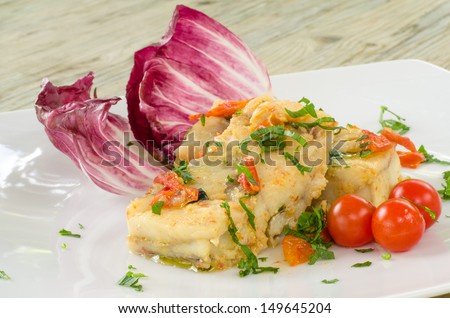 Boiled cod with tomato and parsley