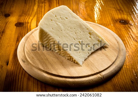 Slice of fresh pecorino, sardinian cheese with sheep milk