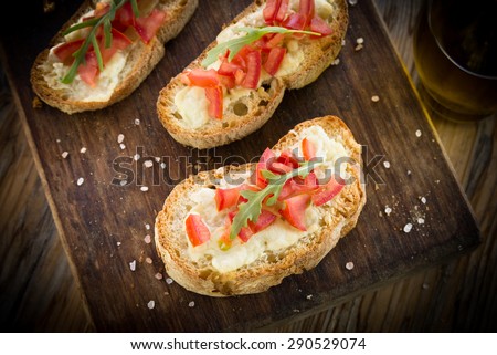 Bruschette with fresh tomato and melted cheese, Italian Finger Food