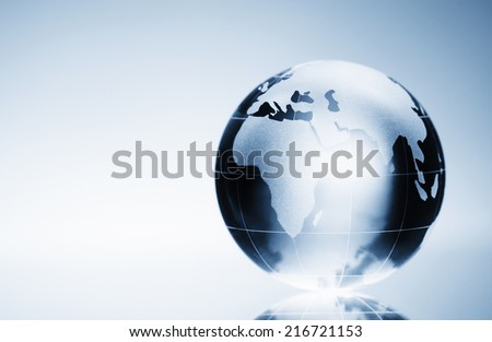 Glass globe on the reflective surface, with copy space.