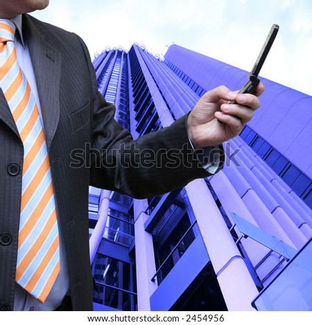 Businessman surfing the internet on his cellphone