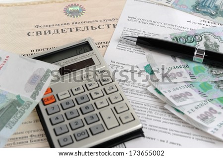 Calculator, money, pen and tax act against the background of the certificate close
