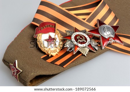 Military cap with Saint George ribbon and orders of Great Patriotic war on gray