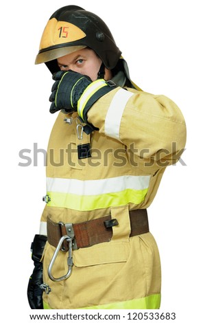 Firefighter protects the face with one hand. Isolated on white background