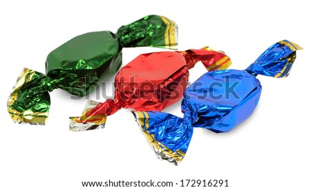 Three chocolate candies with wrappers of different colors on a white background