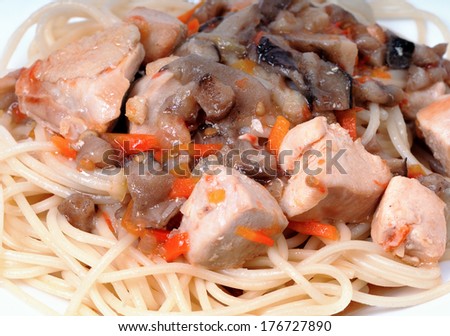 Goulash of fried chicken breasts and mushrooms with carrot closeup