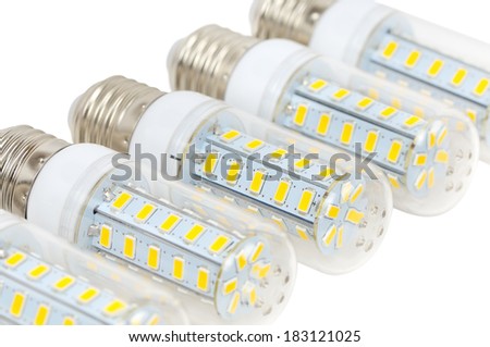 Multiple LED bulbs corn lying side by side on a white background