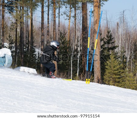 Winter sports. A boy skiing on the road