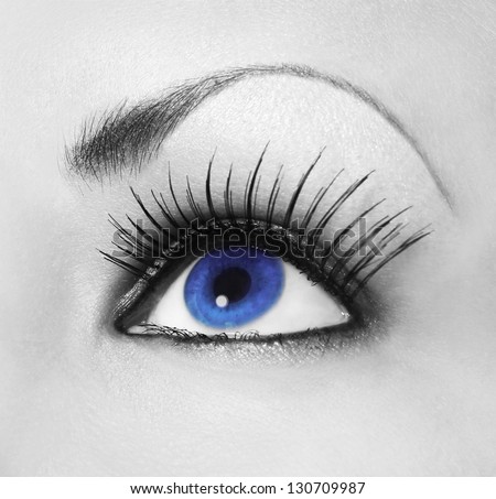 Blue eye with long eyelashes, black and white, contact lens