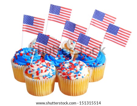 Patriotic cupcakes decorated with American Flags and blue, white cream with red stars sprinkles on the top, isolated on white background.