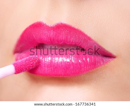 Hot Pink Lipstick. Lip Gloss on Sexy Lips and Brush. Makeup.