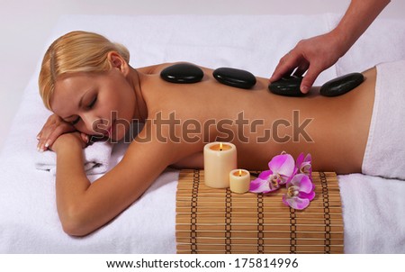 Spa Stone Massage. Beautiful Blonde Woman Getting Hot Stones Massage. Beauty Treatments.
