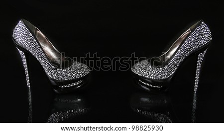 crystals encrusted black shoes on black background