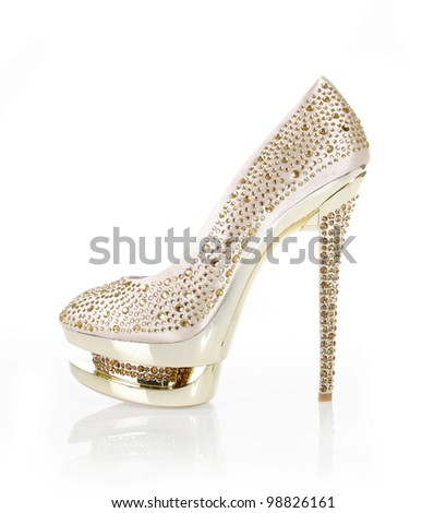 crystals encrusted gold shoe isolated on white