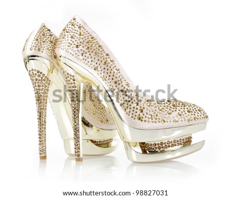 crystals encrusted gold pair of shoes isolated on white