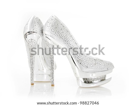 crystals encrusted silver pair of shoes on white background