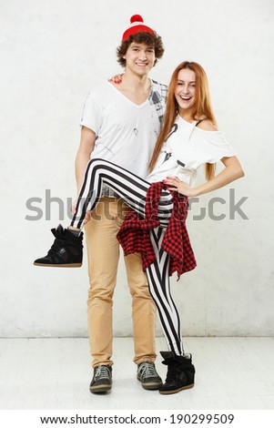 Man and woman standing on a white floor and white background fooled on textured walls