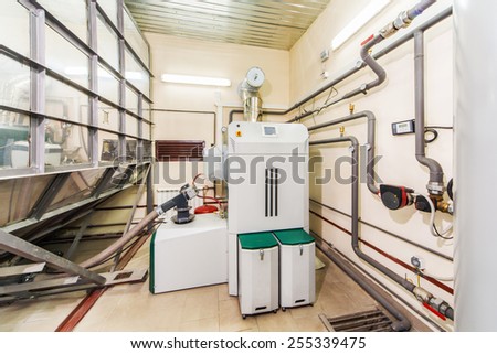 Interior boiler with a boiler on fuel from wood auger.