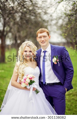 Wedding portrait of the bride and groom in the spring garden.