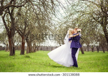 Wedding portrait of the bride and groom in the spring garden.