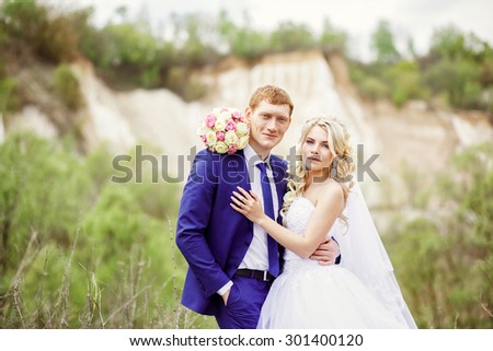 portrait of the bride and groom on the background of white cliffs.