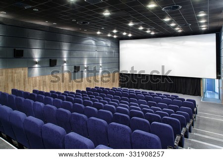 Interior cinema hall with plenty of seating and a bigÃ?Â screen.