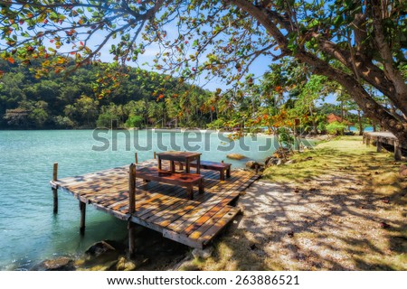 Tropical island, a table in the shade of trees. Thailand Koh Ngam.