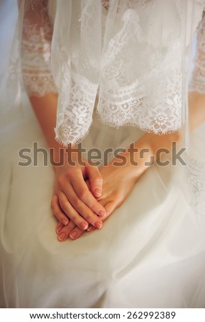 hands of the bride, white dress, bride sitting on a  chair