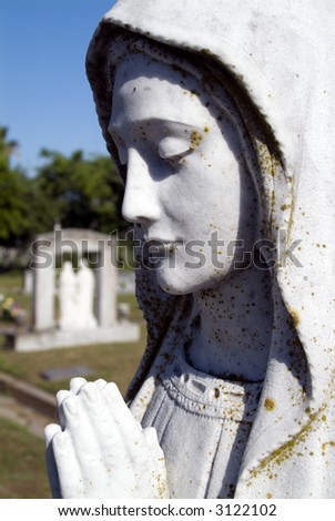 stock photo Cemetery statue depicting Mary praying