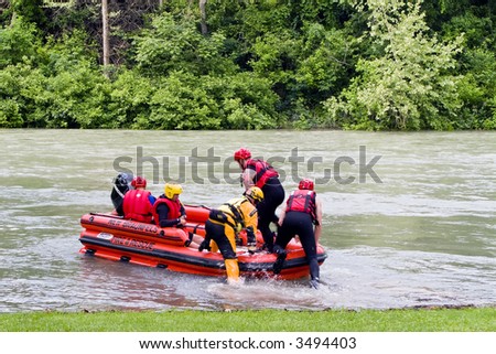 Fire and Rescue team conducting a practice drill on a river after several days of heavy rain.