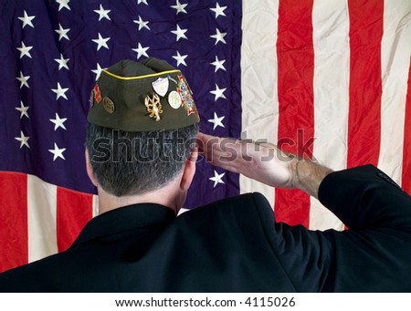 A Veteran wearing a decorated cap, saluting the American Flag.