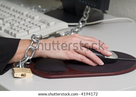 close-up of a woman chained to her desk