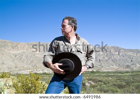 A man appreciatively surveying the rugged beauty surrounding him.