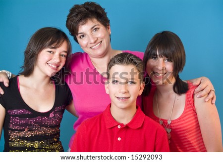 A woman and three adolescent children representing a happy family. (blue screen)
