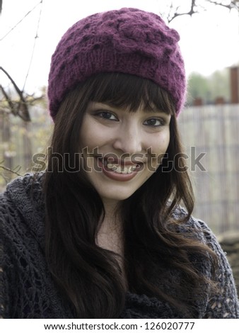 Pretty young woman in pink woolly hat