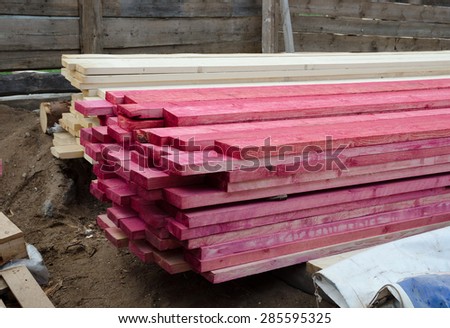 building supplies, stacked wood boards treated with antiseptic spray