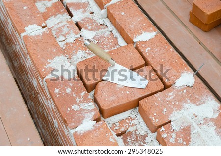 Mason bricklaying background with trowel clay brick blocks