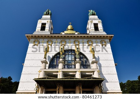 art deco church in vienna with golden cuppola in front of blue sky