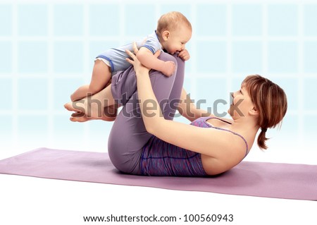 Yoga for woman and child / Mother with her baby boy doing Yoga exercises